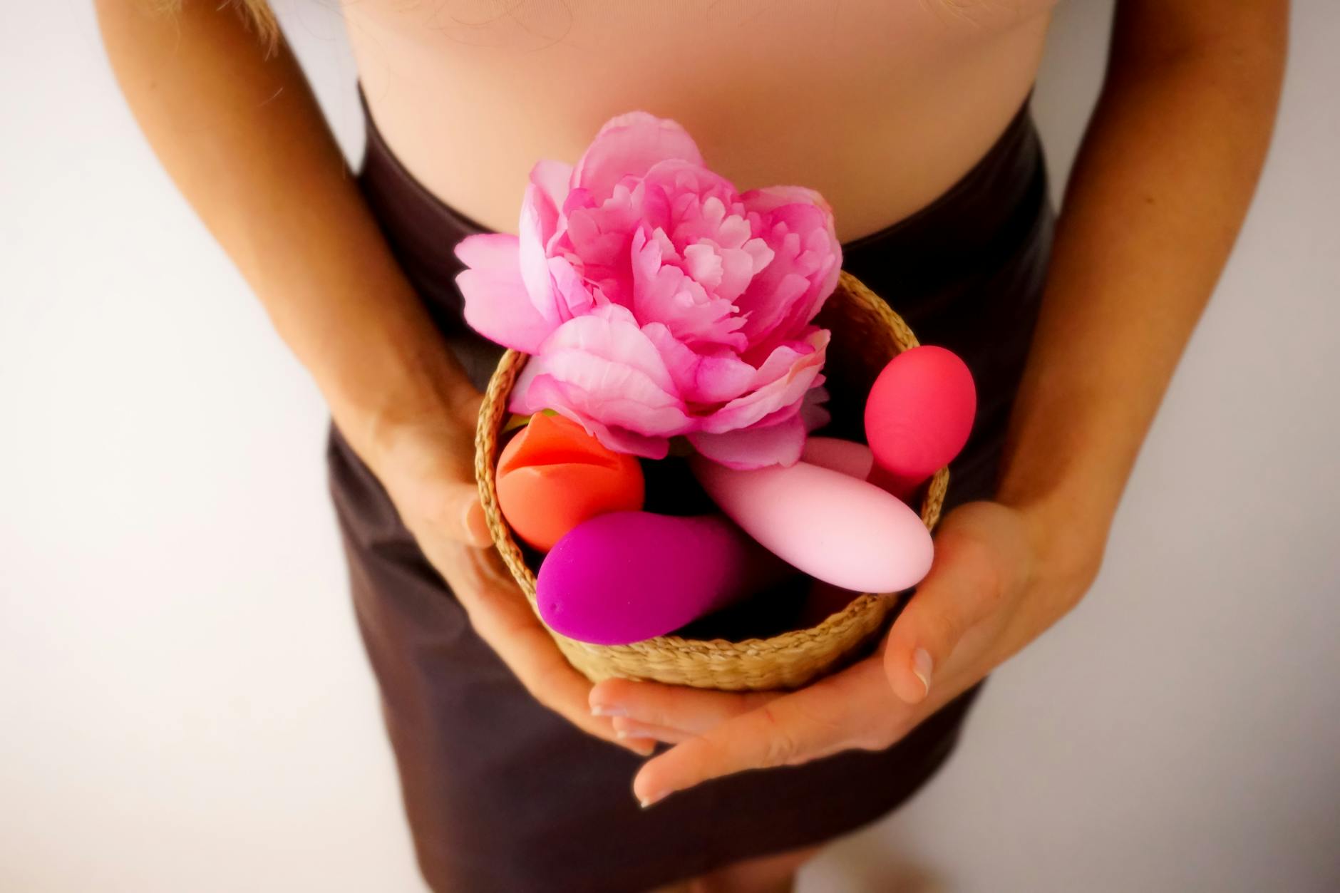 Pink lemon vibrator on purple background with heart confetti and candles
