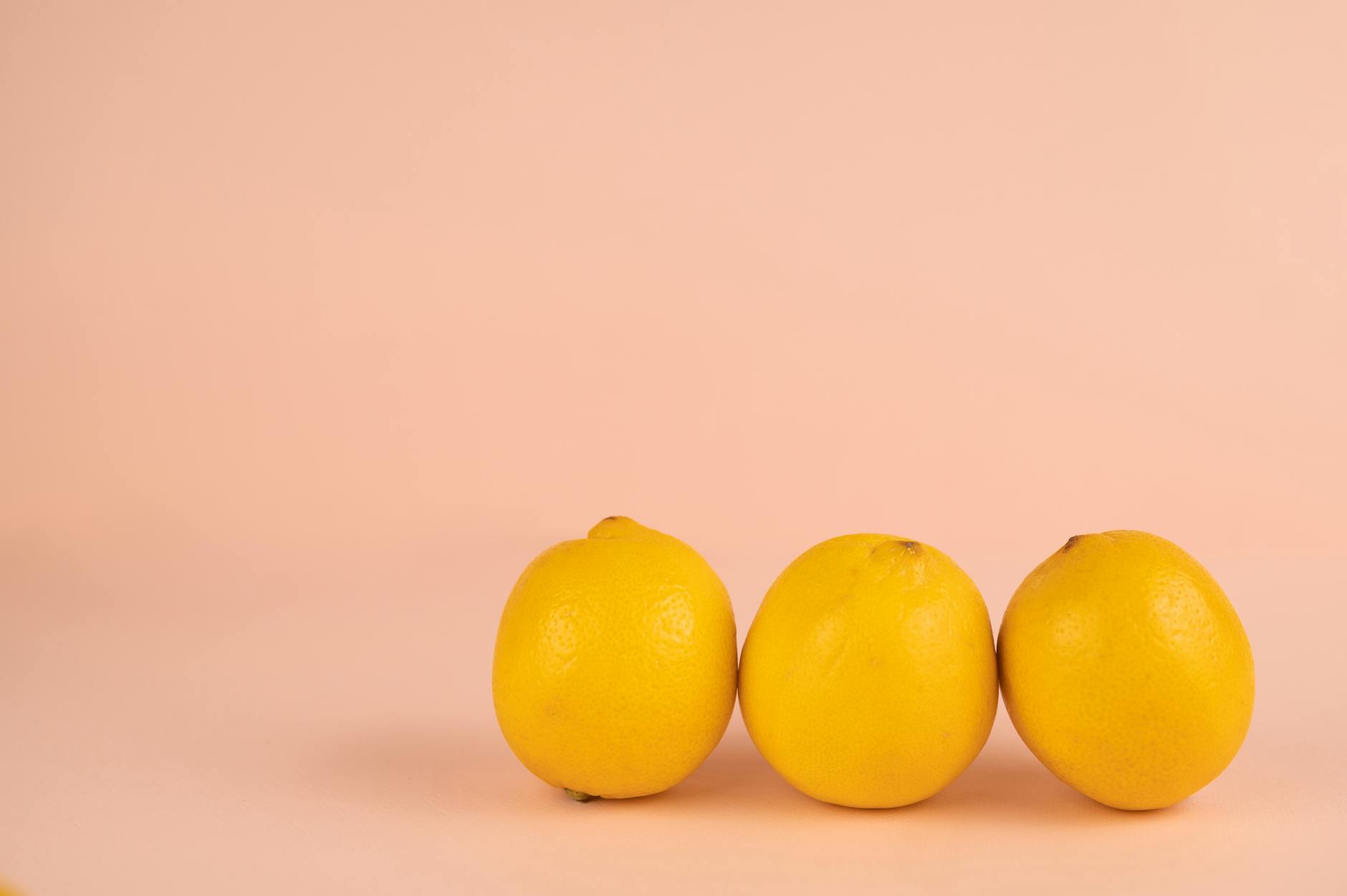 Bright ripe lemons arranged on a pastel background, symbolizing fresh approaches to pleasure
